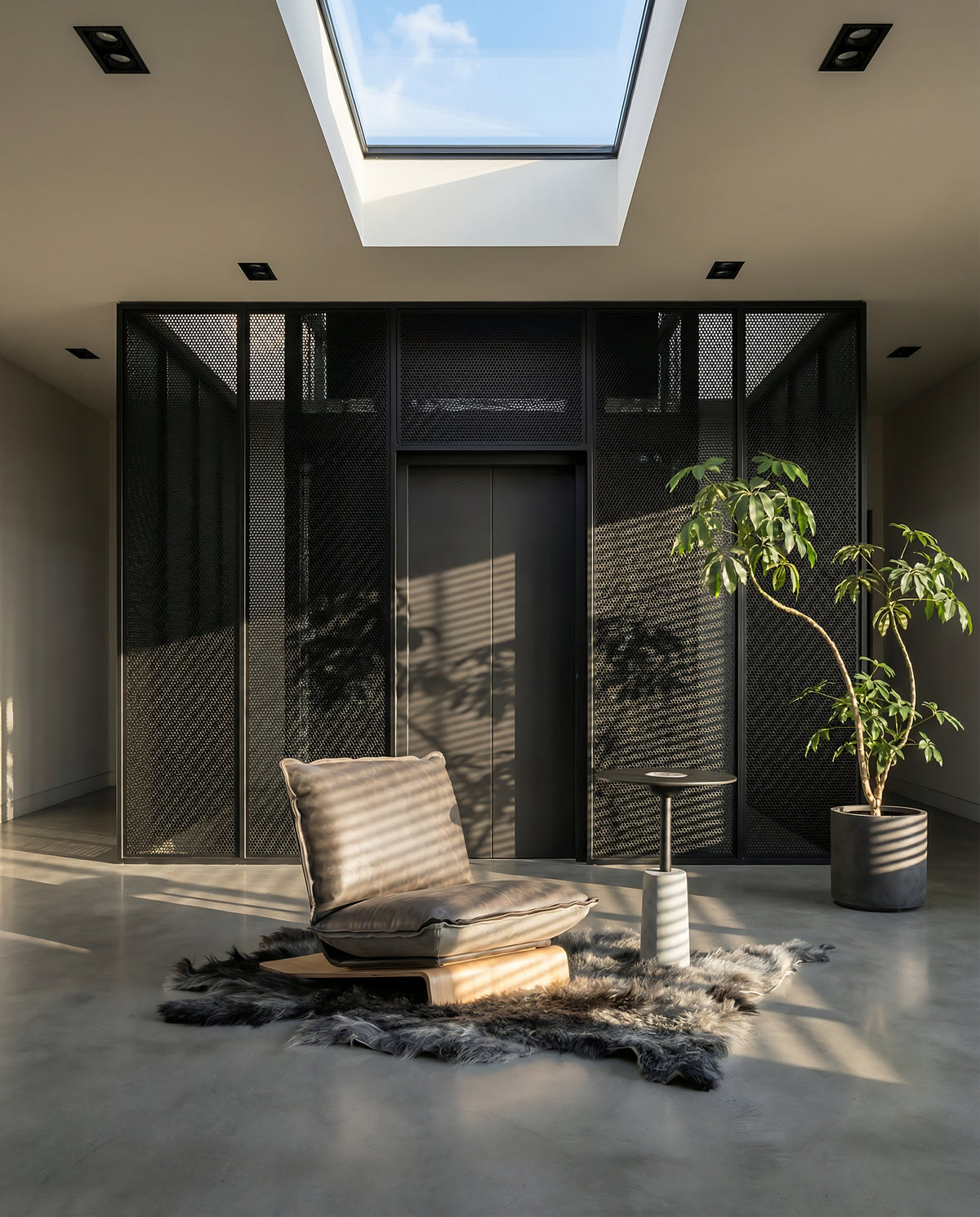 NOMAD Skin Lounge Chair on a fur rug in a skylit lobby