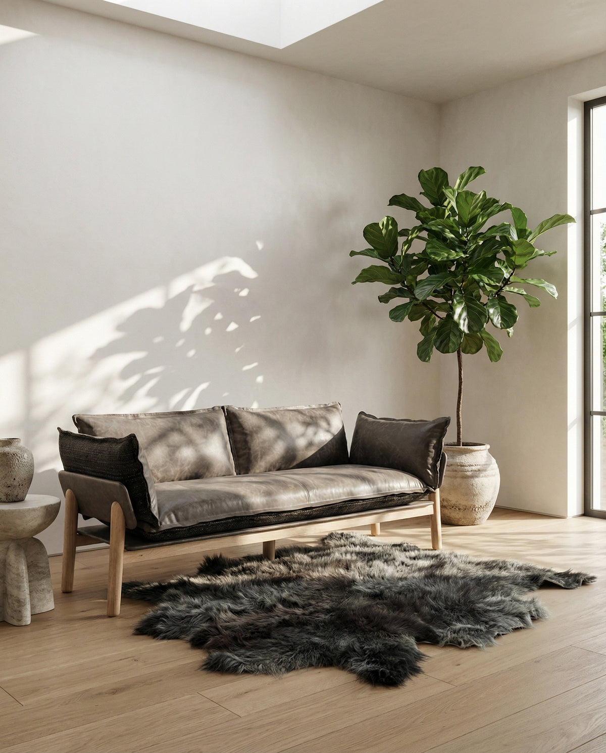 NOMAD Skin Sofa in yak leather with sheepskin rug in a sunlit interior