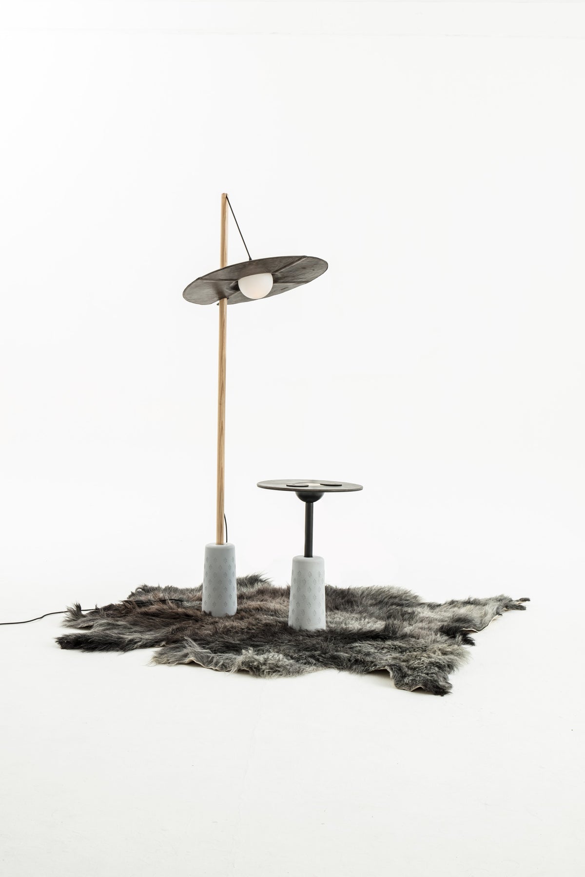 NOMAD Drumroll floor lamp with wood, cement and yak leather – studio shot