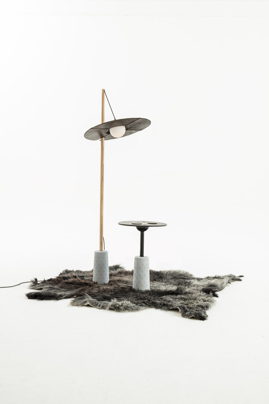 NOMAD Drumroll floor lamp with wood, cement and yak leather – studio shot